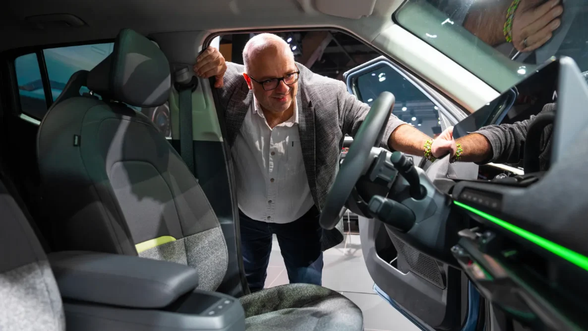 Phil Huff looking inside the Kia EV2 at the Brussles Motor Show
